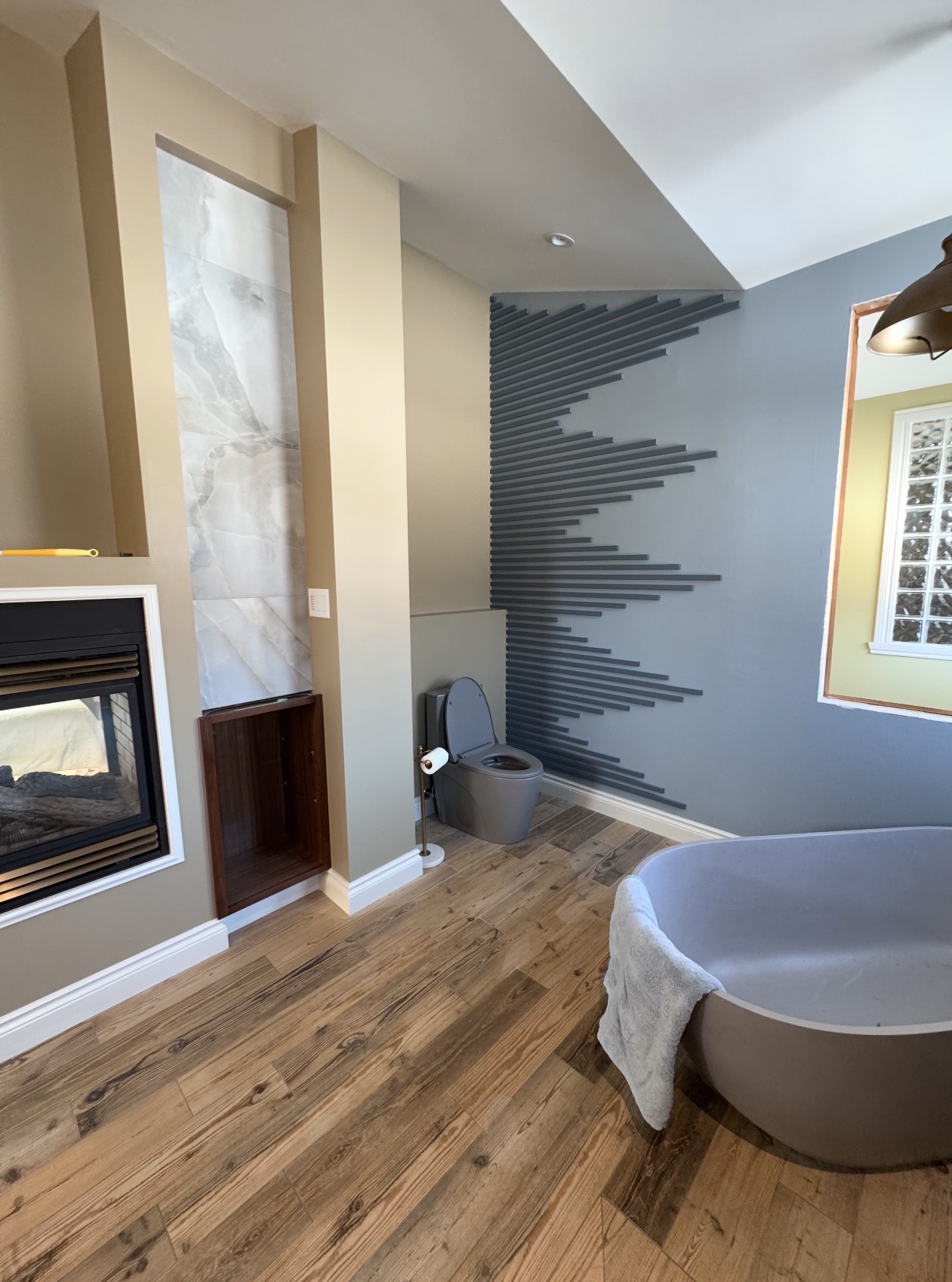 Floor-to-ceiling herringbone tile ensuite with freestanding soaker tub, Orleans bathroom renovation